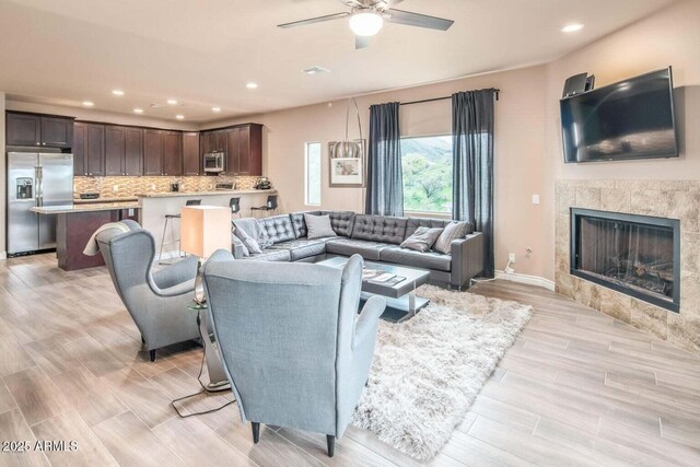 6145 E Cave Creek Rd Unit 203, Cave Creek, AZ 85331 - living area featuring a ceiling fan, recessed lighting, light wood-style flooring, and a high end fireplace