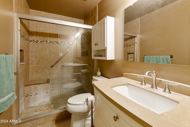 bathroom featuring vanity, an enclosed shower, and toilet