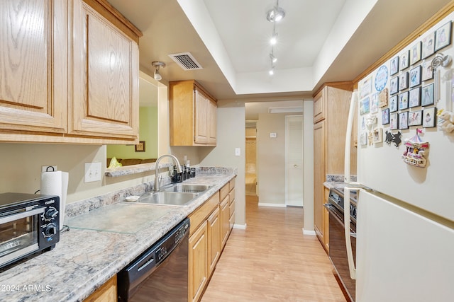 kitchen with light stone counters, sink, black appliances, light brown cabinetry, and light hardwood / wood-style floors