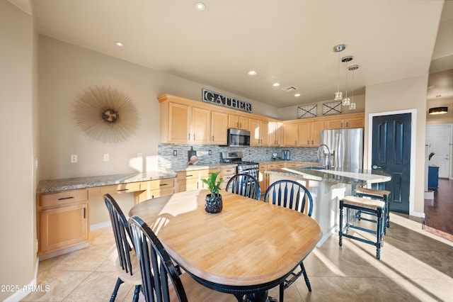 tiled dining room featuring sink