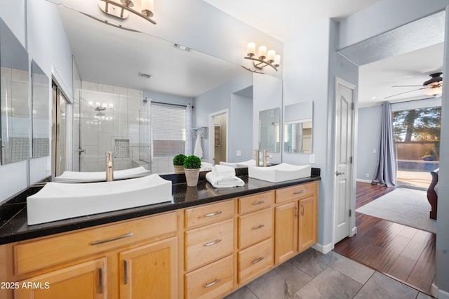 bathroom with ceiling fan, vanity, a shower with door, and wood-type flooring