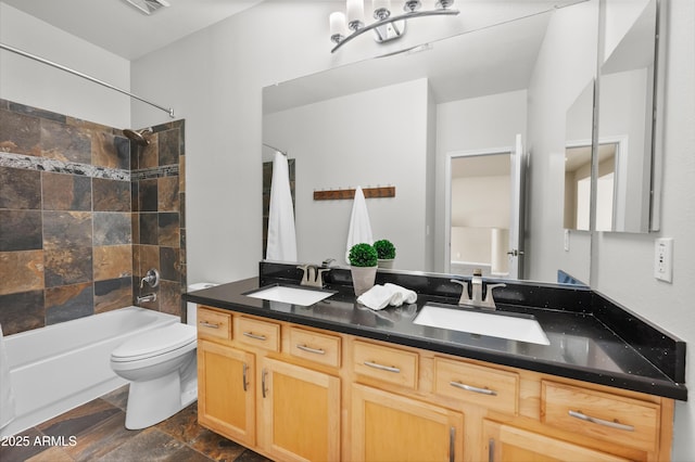 full bathroom featuring vanity, toilet, and tiled shower / bath combo