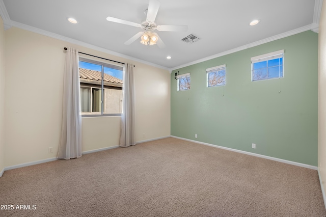 carpeted empty room with a wealth of natural light, ornamental molding, and ceiling fan