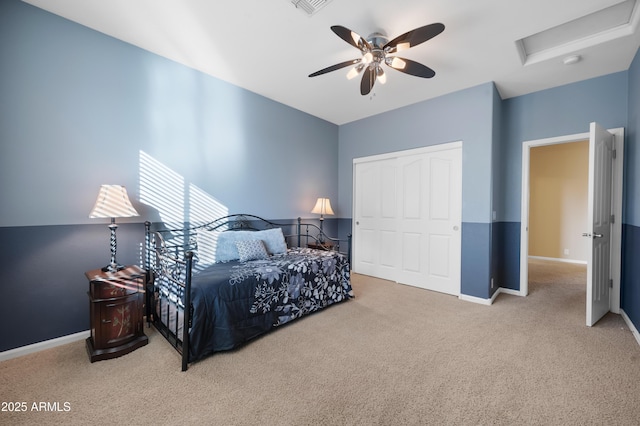 carpeted bedroom featuring a closet and ceiling fan