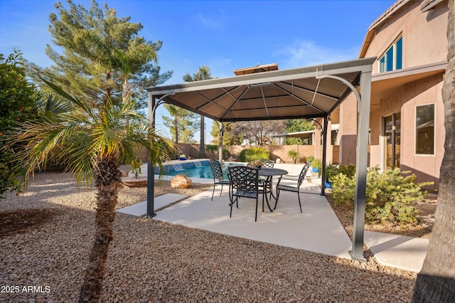 view of patio / terrace featuring a fenced in pool and a gazebo