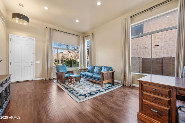 sitting room with dark wood-type flooring