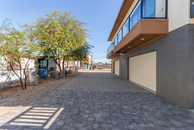 exterior space with a garage and a balcony