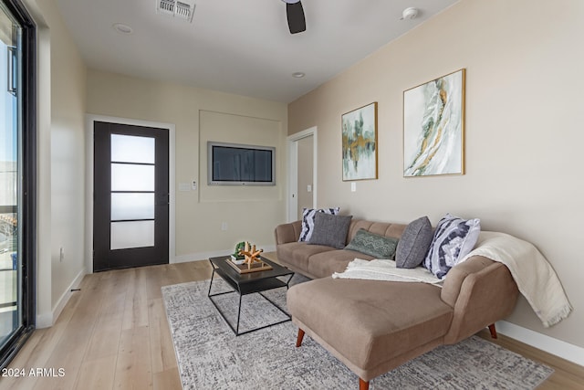 living room featuring ceiling fan and light hardwood / wood-style flooring