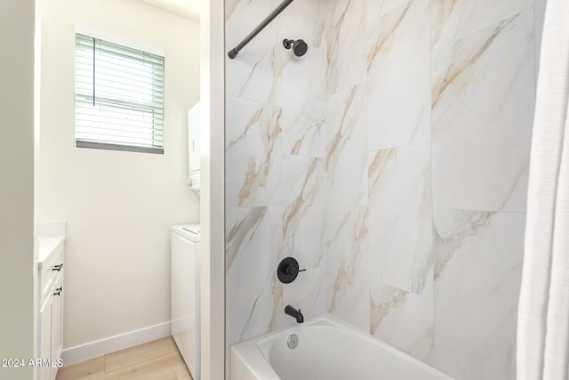 bathroom featuring vanity, tiled shower / bath, and wood-type flooring