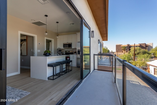 balcony featuring an outdoor wet bar