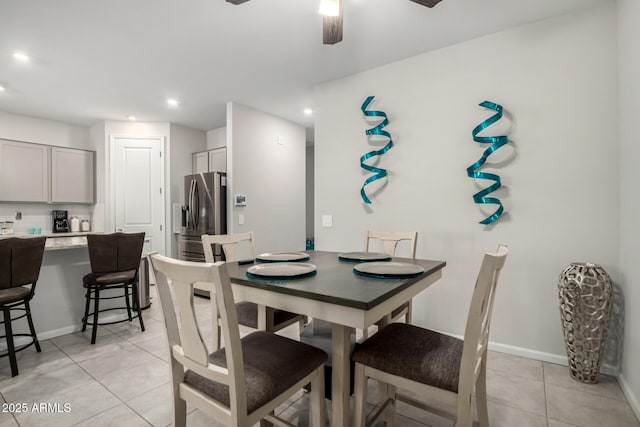 dining space with light tile patterned floors, ceiling fan, recessed lighting, and baseboards