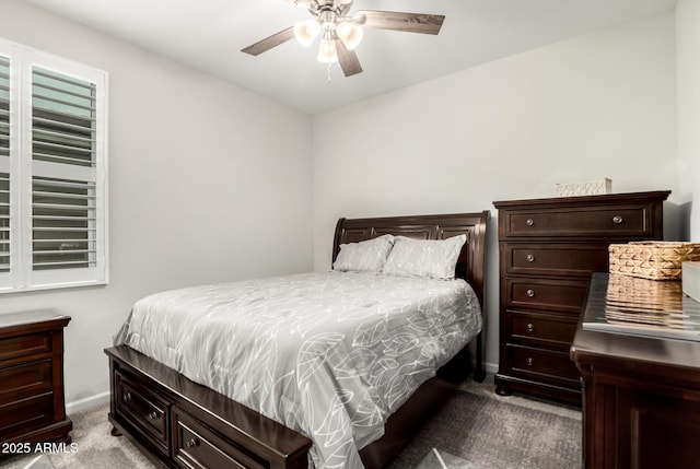 carpeted bedroom featuring baseboards and a ceiling fan