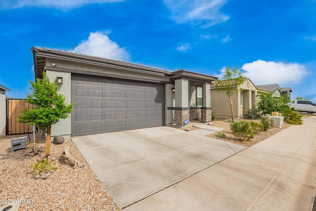 view of front facade featuring stucco siding, driveway, a garage, stone siding, and a tile roof