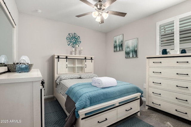 bedroom featuring dark colored carpet, baseboards, and ceiling fan