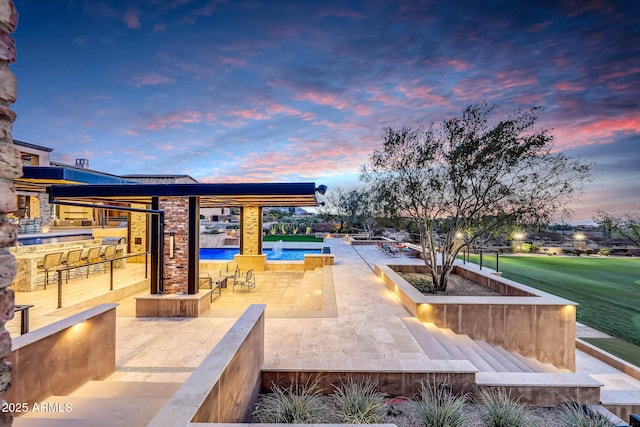 view of patio terrace at dusk