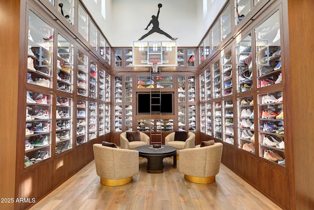 wine room featuring wood walls and wood-type flooring