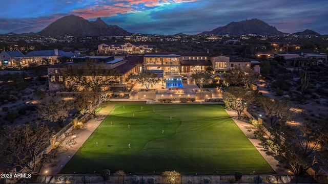 aerial view at dusk featuring a mountain view