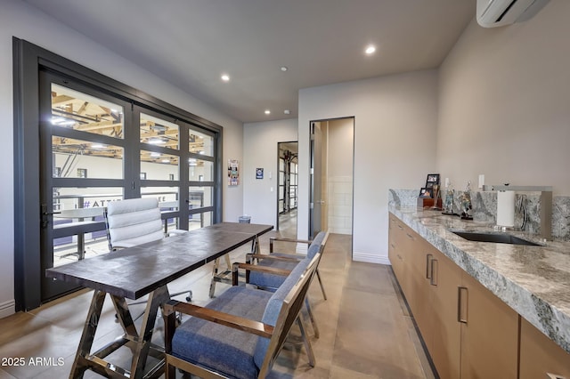 dining room with a wall unit AC and sink