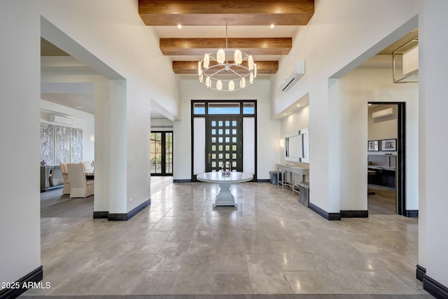 foyer featuring a wall mounted AC, french doors, beamed ceiling, and a chandelier