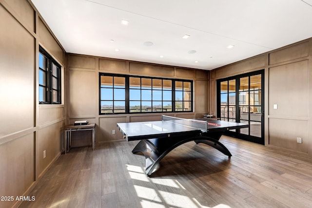 rec room featuring french doors and light wood-type flooring