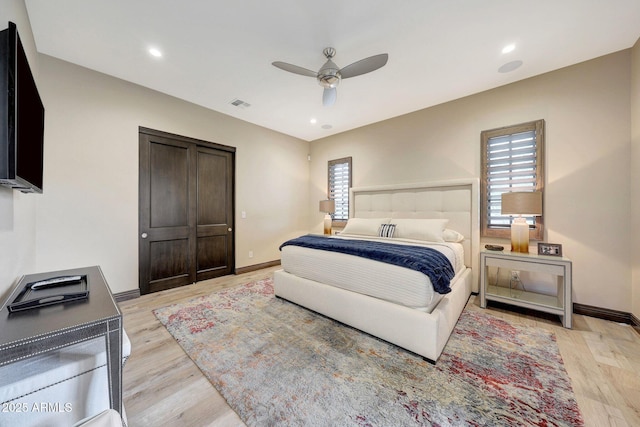 bedroom with ceiling fan and light hardwood / wood-style floors