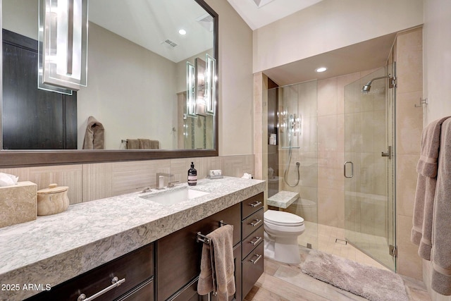 bathroom with vanity, toilet, decorative backsplash, and walk in shower