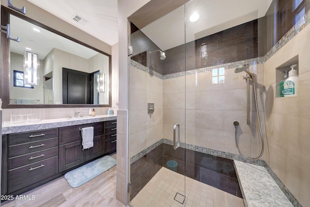 bathroom featuring vanity and an enclosed shower