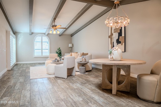 sitting room featuring hardwood / wood-style flooring, vaulted ceiling with beams, and ceiling fan with notable chandelier