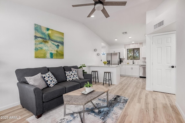 11025 E Cholla Rd, Mesa, AZ 85207 - living room with light wood finished floors, ceiling fan, vaulted ceiling, baseboards, and recessed lighting