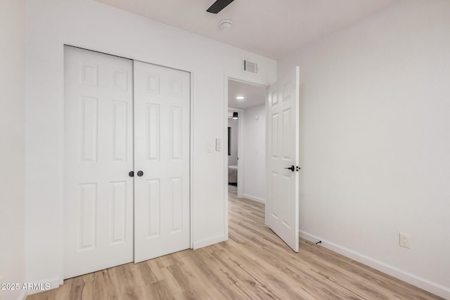 11025 E Cholla Rd, Mesa, AZ 85207 - unfurnished bedroom featuring light wood-style floors, baseboards, and a closet