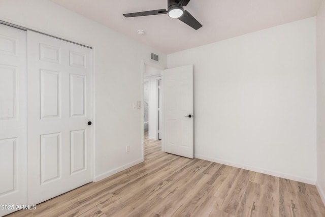 11025 E Cholla Rd, Mesa, AZ 85207 - unfurnished bedroom with light wood-type flooring, baseboards, a closet, and a ceiling fan