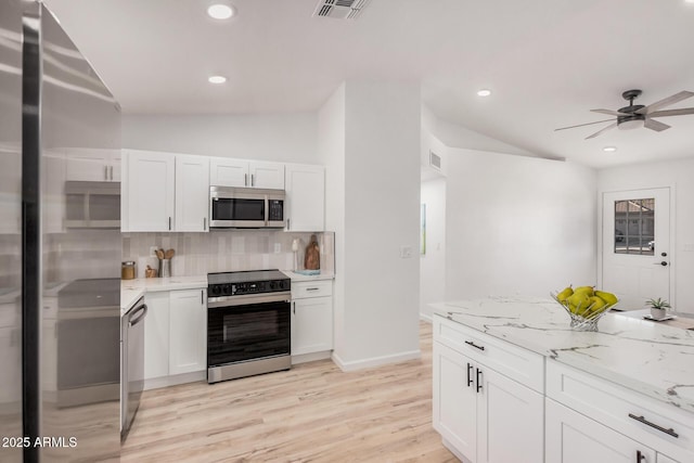 11025 E Cholla Rd, Mesa, AZ 85207 - kitchen with stainless steel appliances, vaulted ceiling, backsplash, ceiling fan, and white cabinetry
