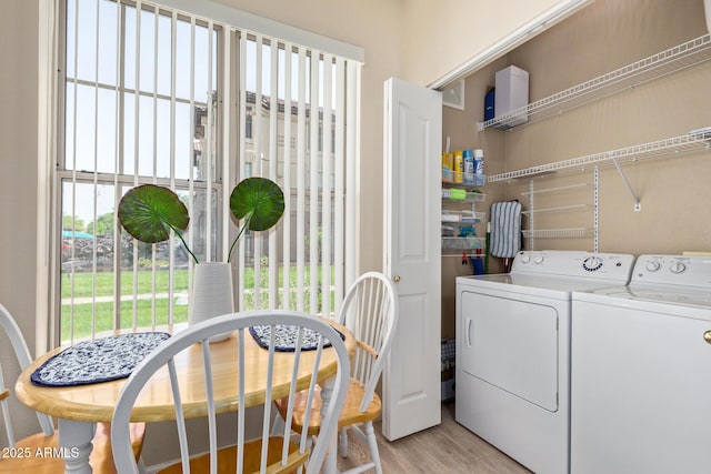 laundry room featuring washer and dryer, laundry area, and light wood-type flooring