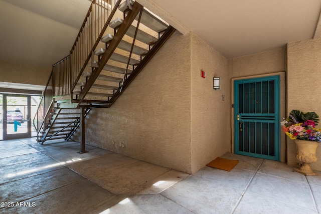 entrance to property with stucco siding