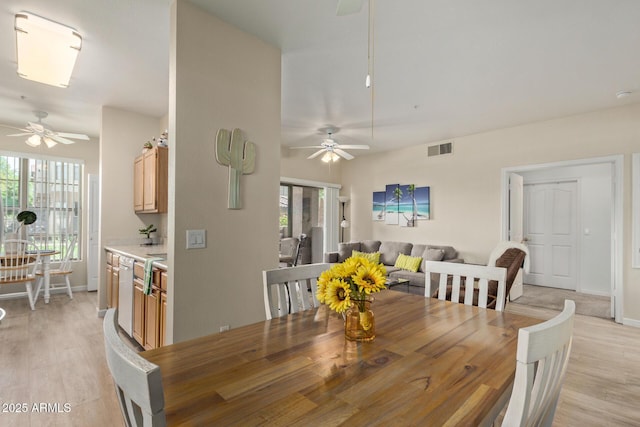 dining area featuring a ceiling fan, visible vents, and a wealth of natural light