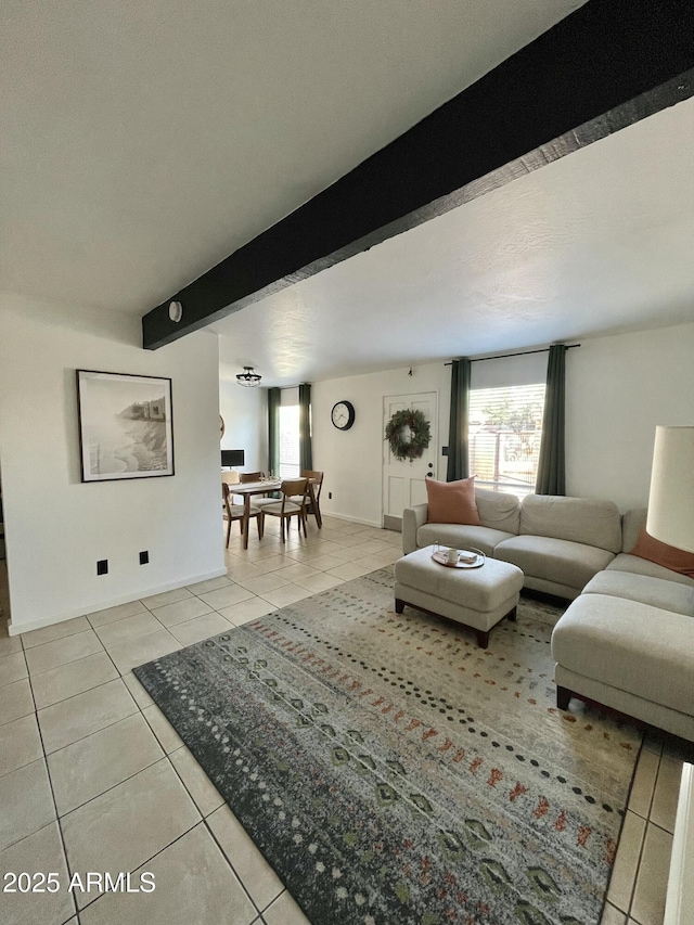 living room featuring light tile patterned floors and beam ceiling