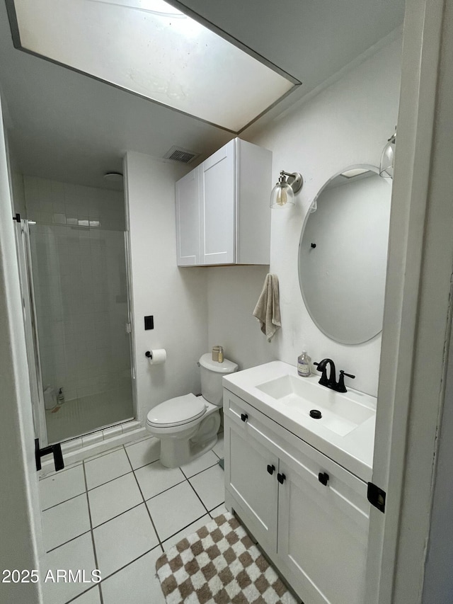 bathroom with vanity, tile patterned flooring, a shower with door, and toilet