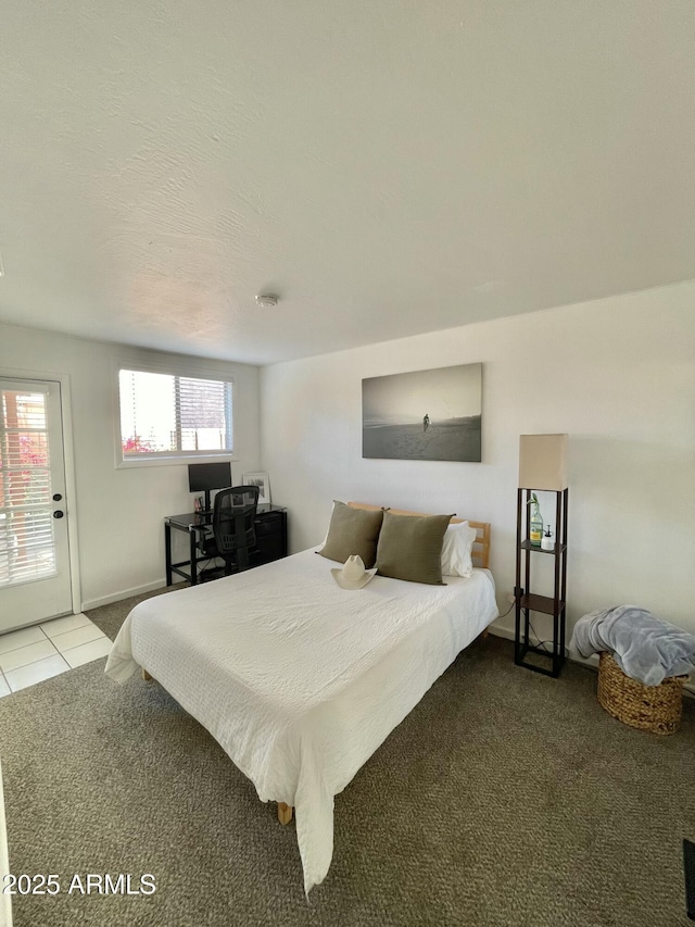 bedroom with tile patterned floors and a textured ceiling