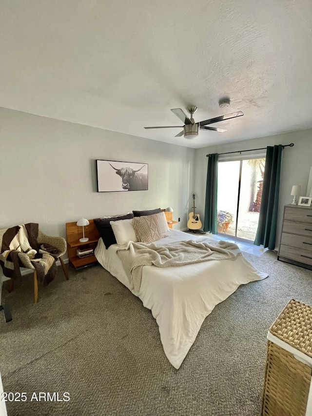 carpeted bedroom with access to outside, a textured ceiling, and ceiling fan