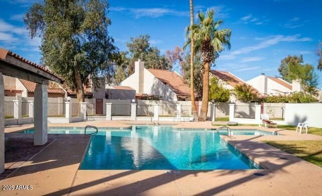 view of pool featuring a community hot tub and a patio area