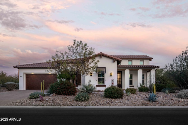 mediterranean / spanish house featuring a garage