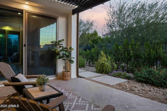 view of patio terrace at dusk