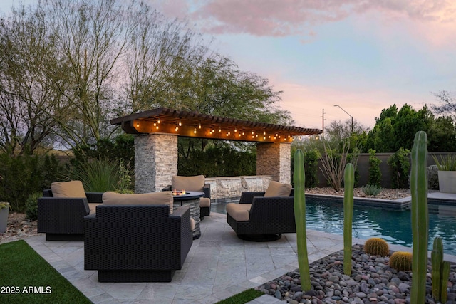 patio terrace at dusk featuring a fenced in pool and an outdoor living space with a fire pit