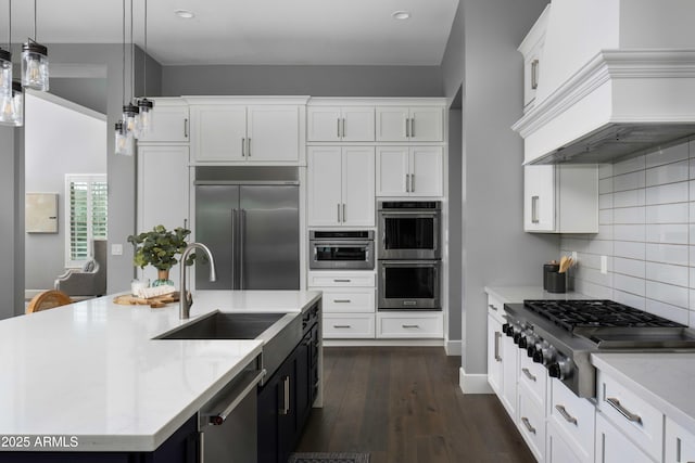 kitchen with stainless steel appliances, pendant lighting, and white cabinetry