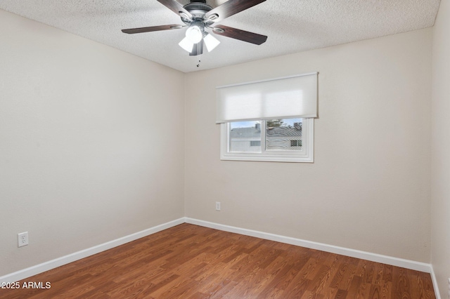 unfurnished room featuring ceiling fan, a textured ceiling, baseboards, and wood finished floors