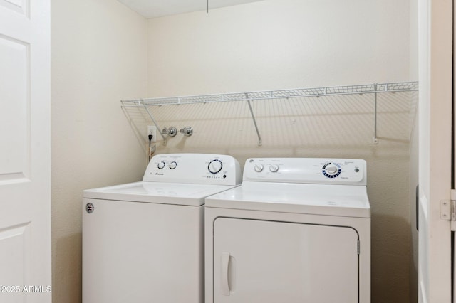 clothes washing area featuring washing machine and dryer and laundry area