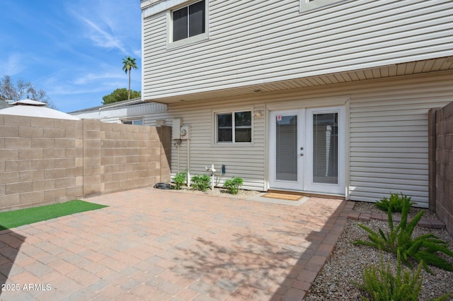 view of patio with french doors and fence