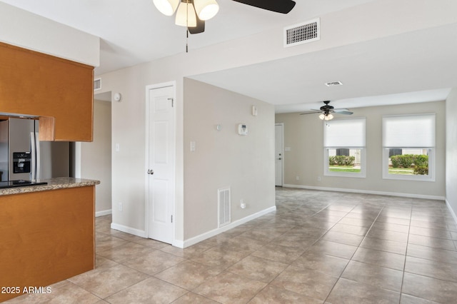 kitchen featuring a ceiling fan, visible vents, and stainless steel fridge with ice dispenser