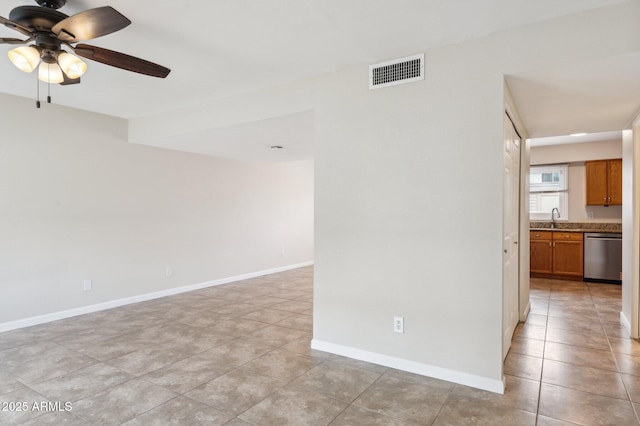 unfurnished room featuring light tile patterned floors, baseboards, visible vents, a ceiling fan, and a sink