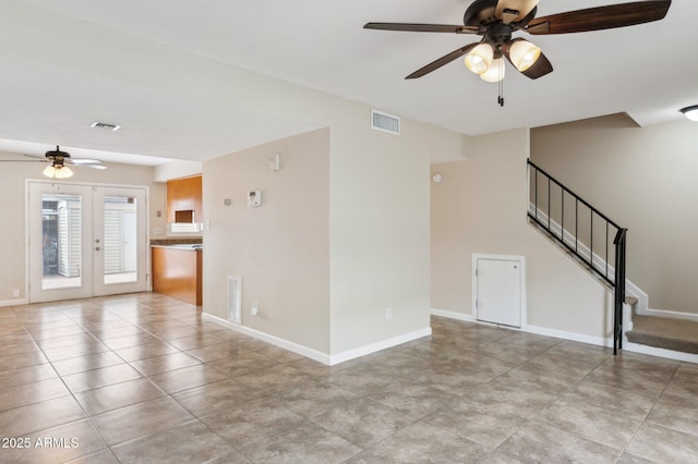 unfurnished living room with stairs, french doors, visible vents, and baseboards